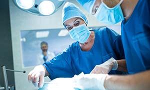 Surgeons performing operation in operation room Surgeons performing operation in operation room at the hospital