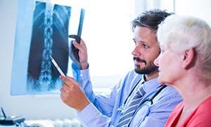Doctor discussing x-ray with patient at the hospital